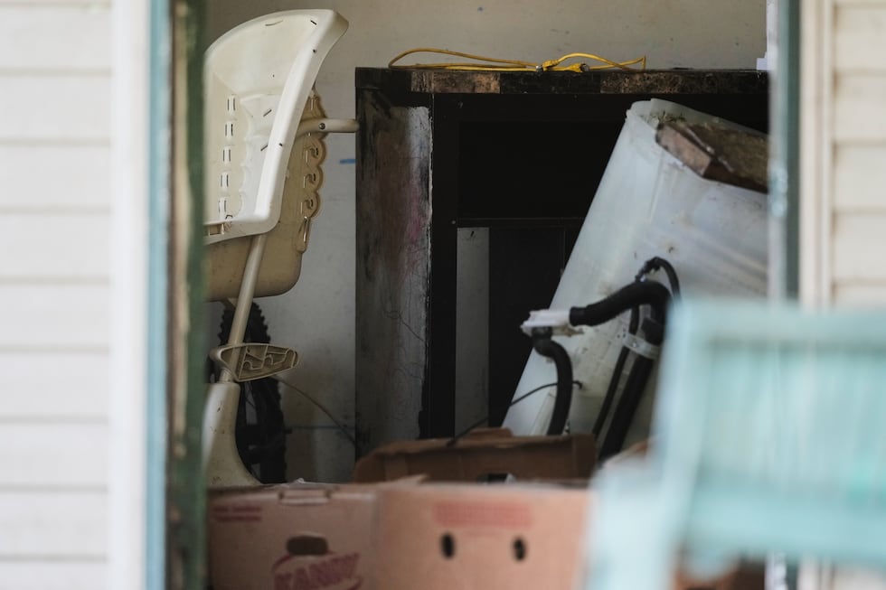 Items including a high chair, left, are seen in a home where authorities say they removed 16...