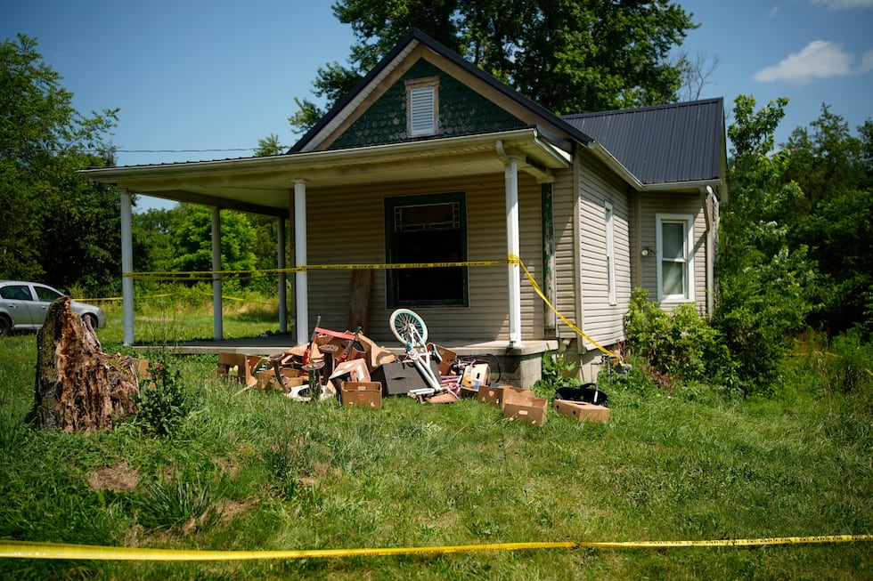 Police tape surrounds a home where authorities say they removed 16 children and arrested four...